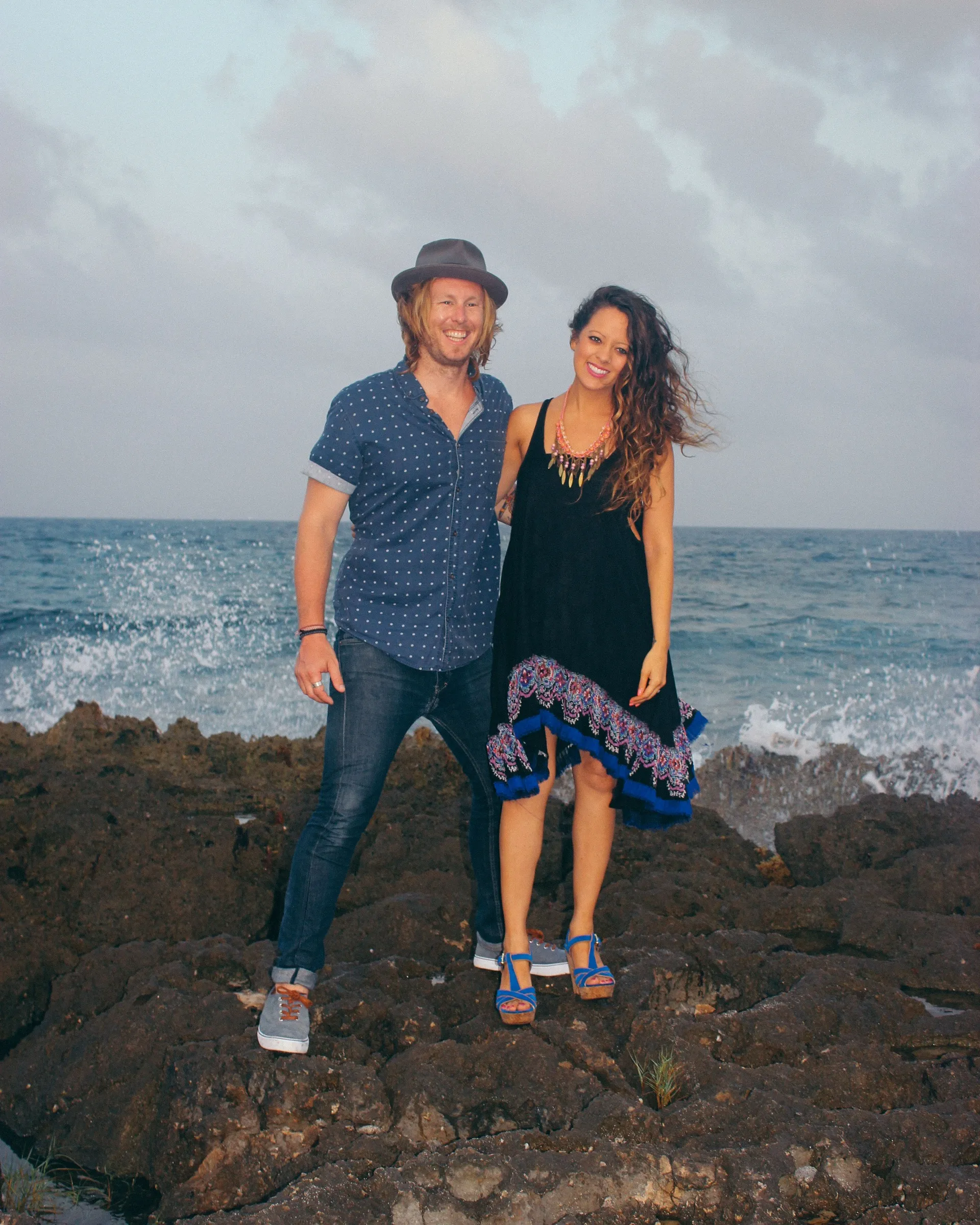 Jamey and Melissa standing together on the rocks above the water in Akumal