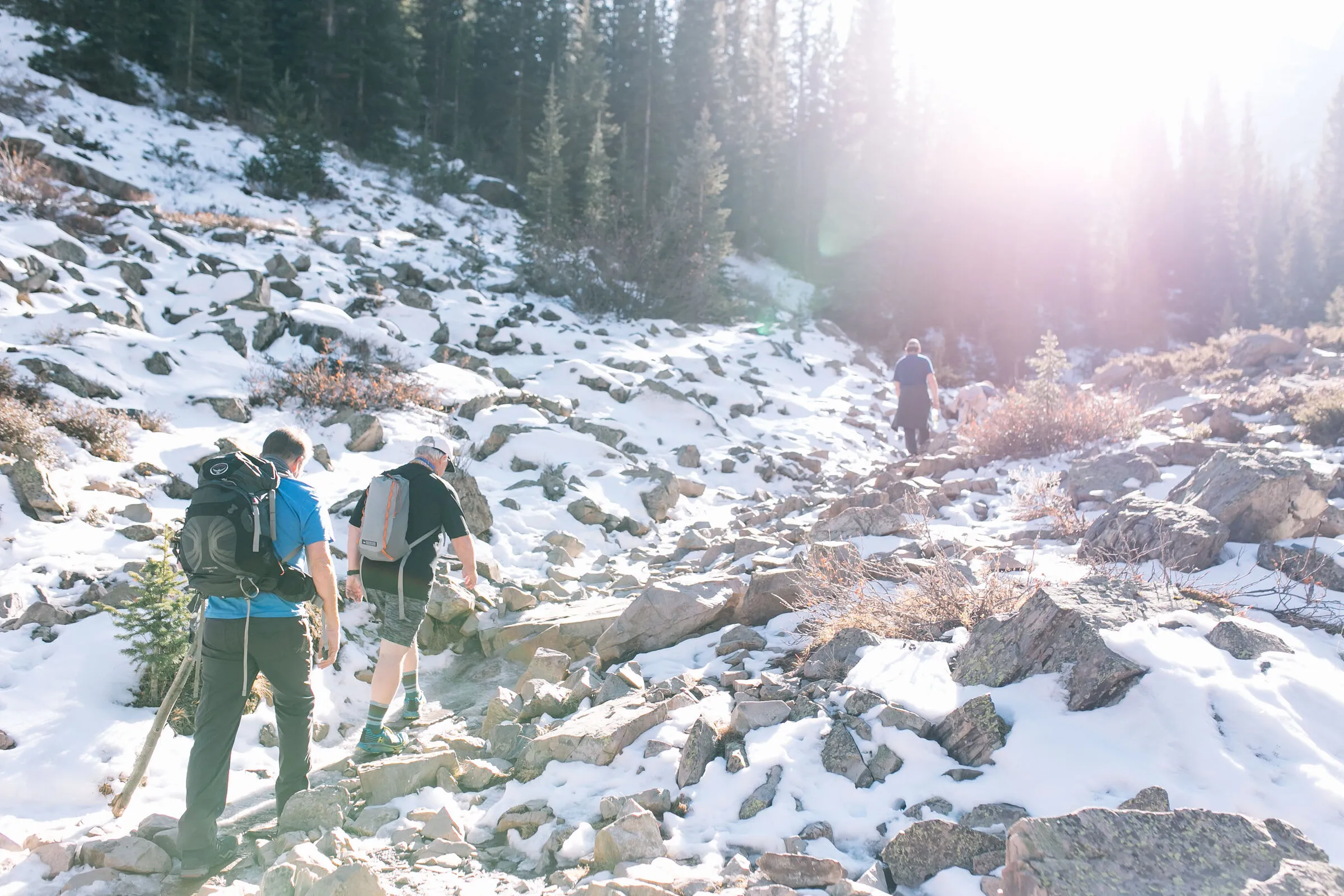 Two hikers heading up the Maroon Bells valley with the first snow on the ground