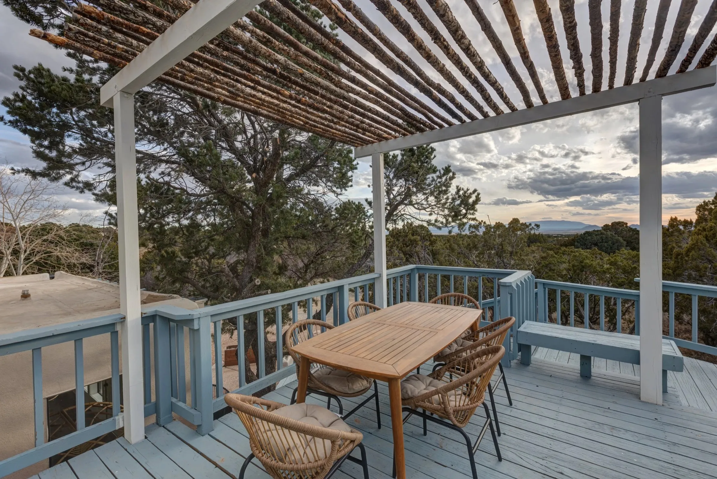 A covered patio with a latilla pergola and open desert views