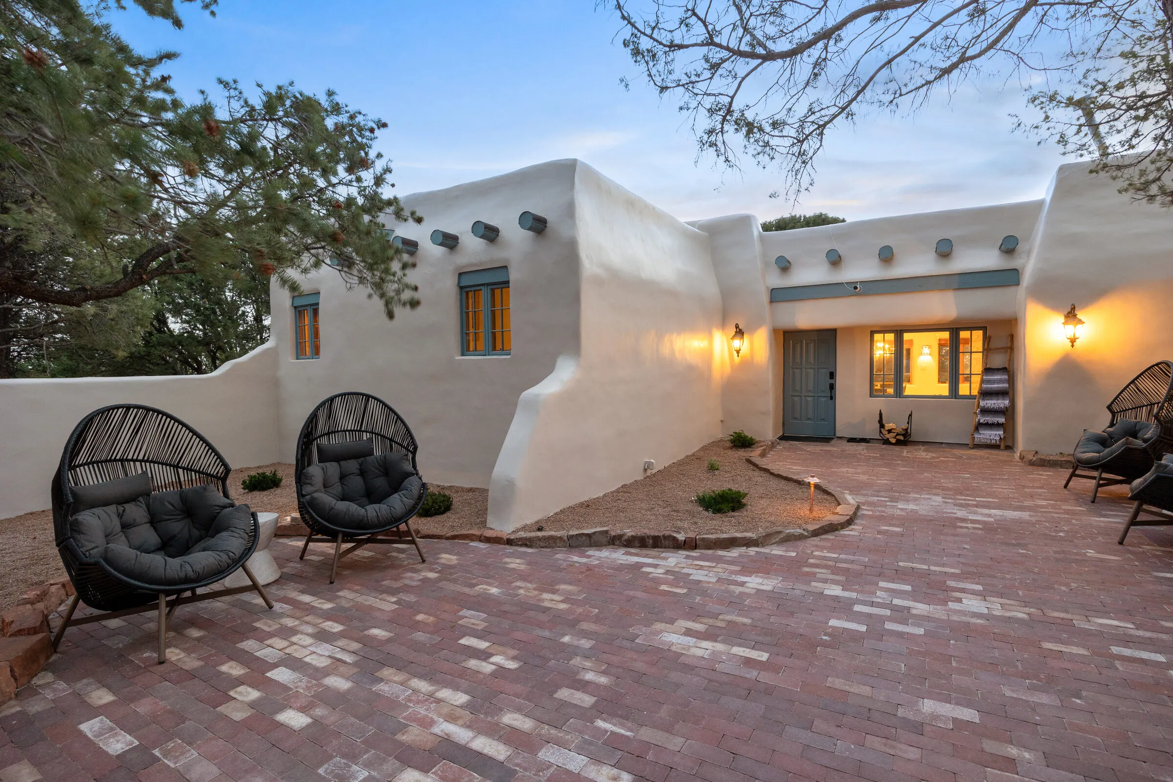Casa de Ice at blue hour — lanterns lit, the walled courtyard glowing