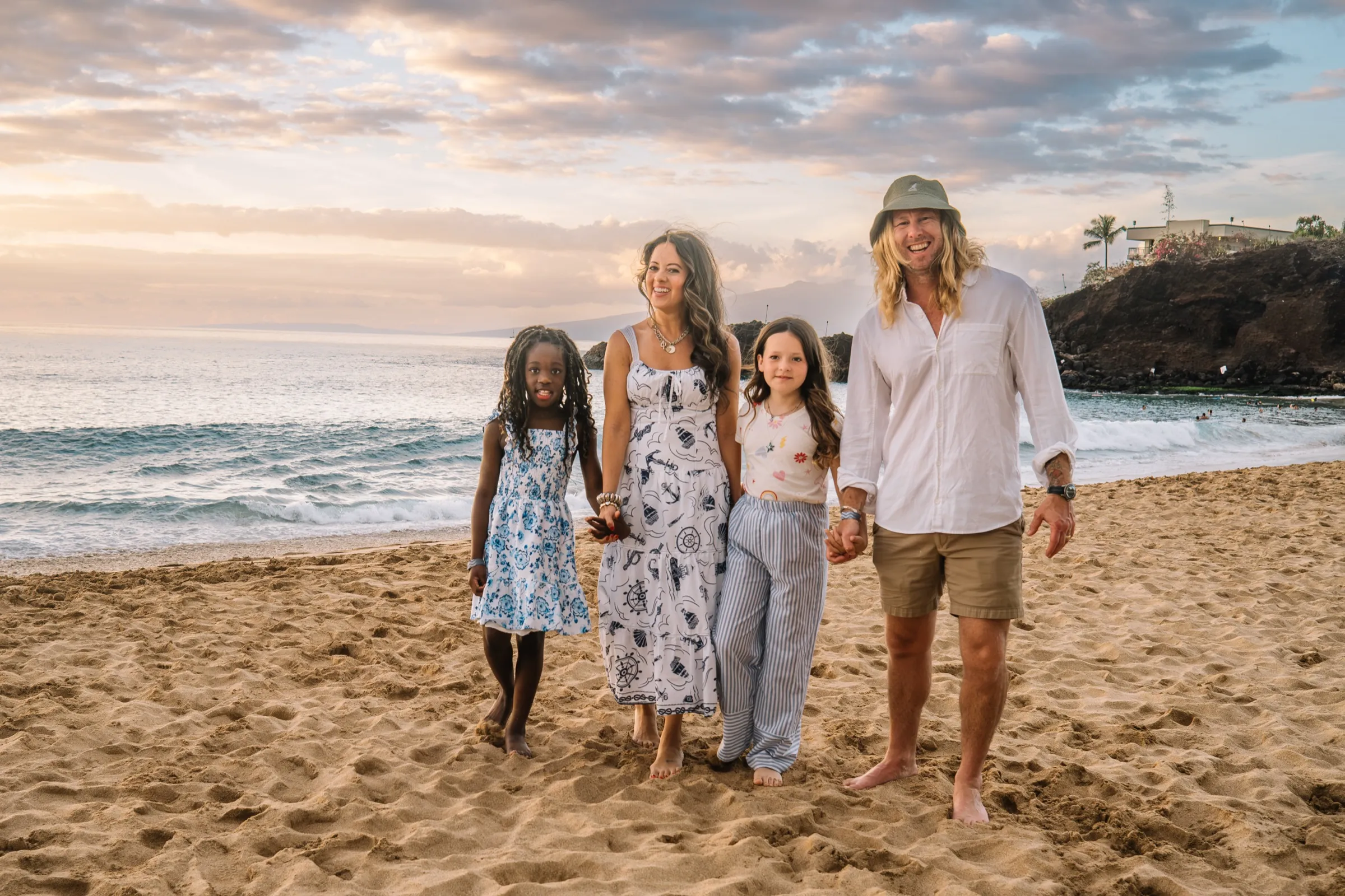 The Ice family walking a Maui beach toward the camera at golden hour