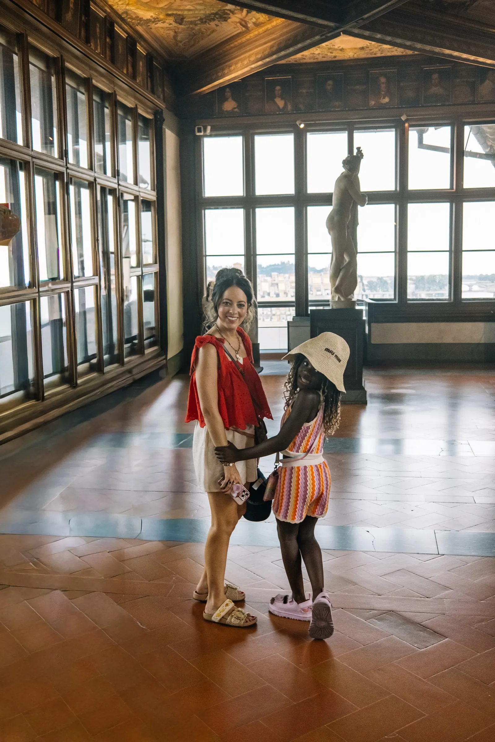 Melissa and Justice hand in hand in a museum hall