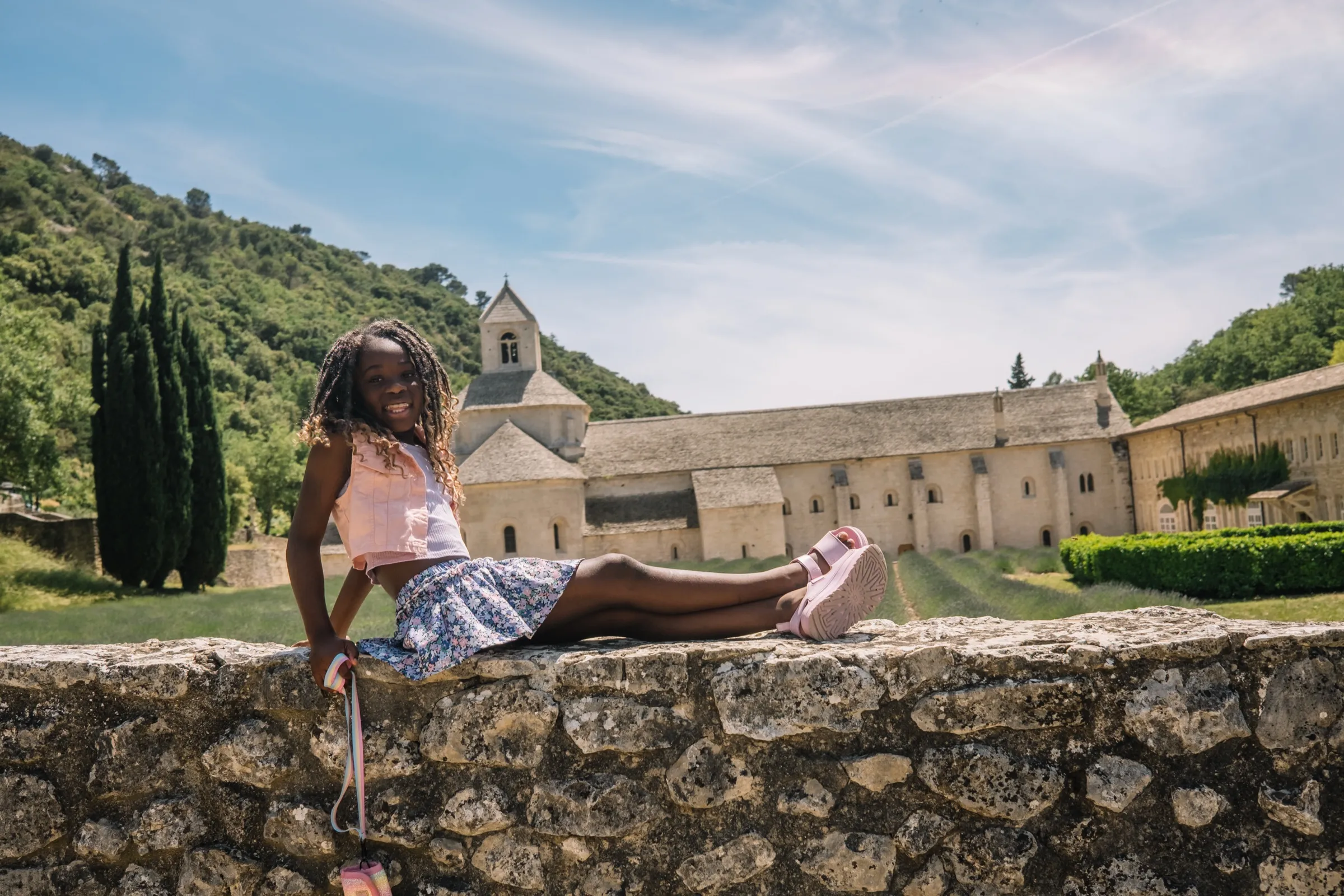 One of the girls on a stone wall above the valley