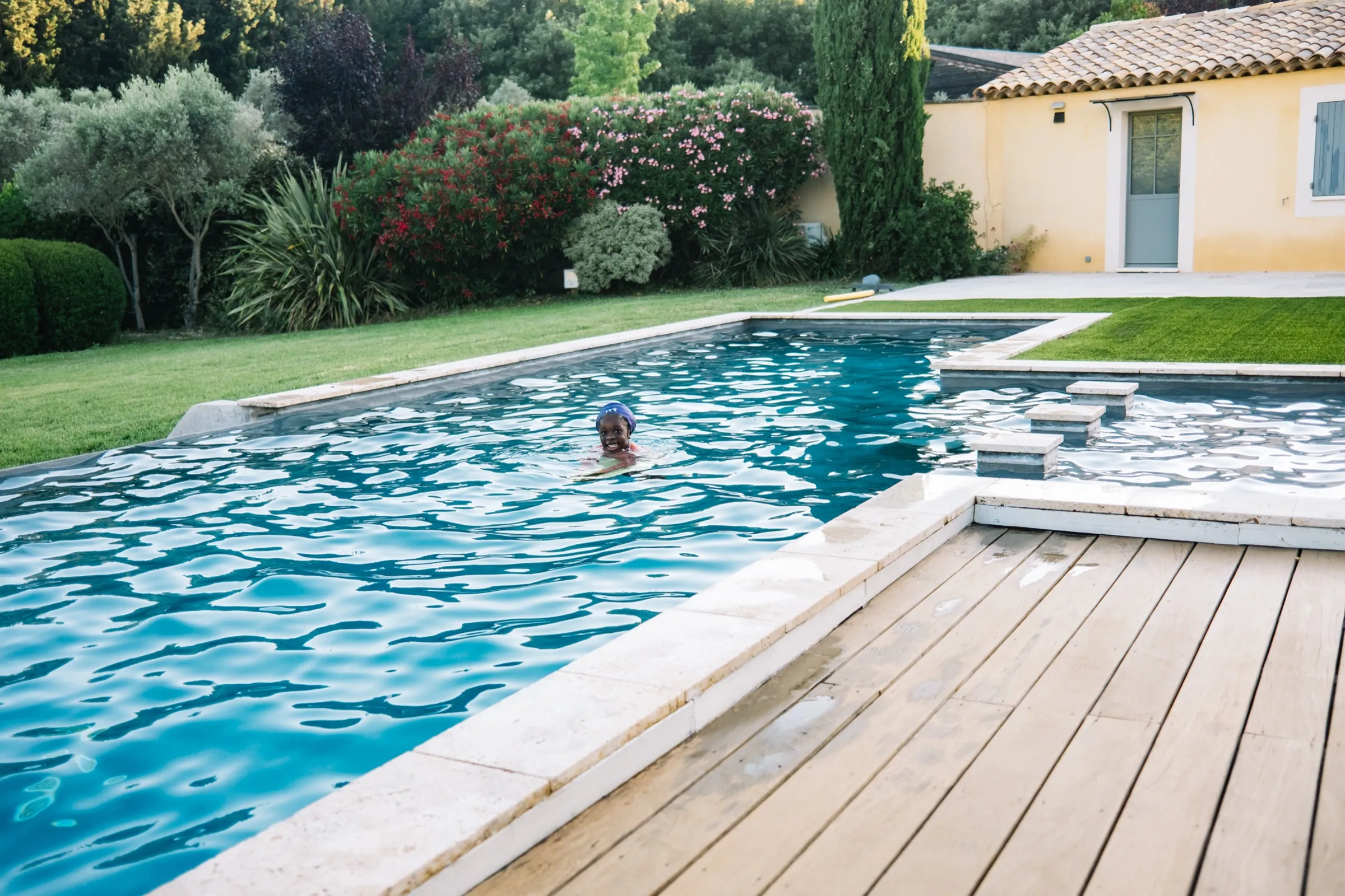 The kids swimming at a villa pool on a summer trip