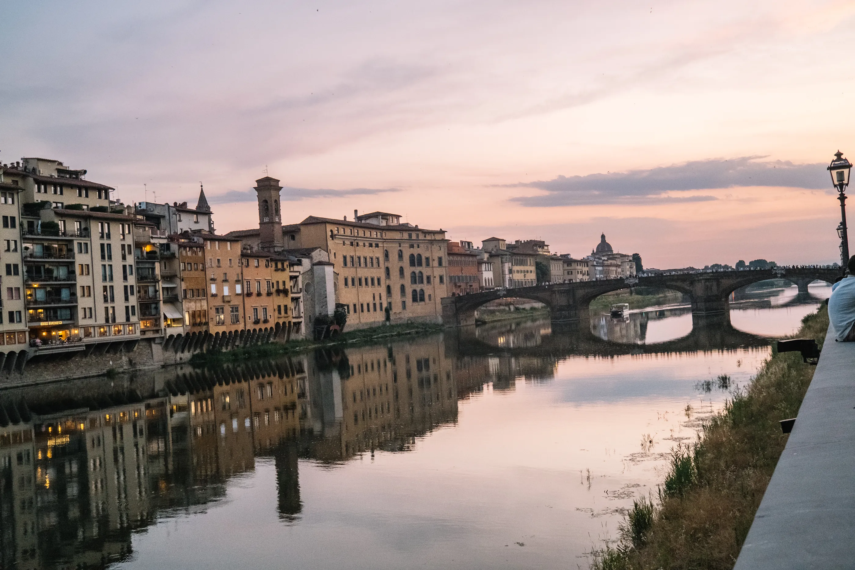 The Ponte Vecchio and the Arno glowing gold at dusk in Florence