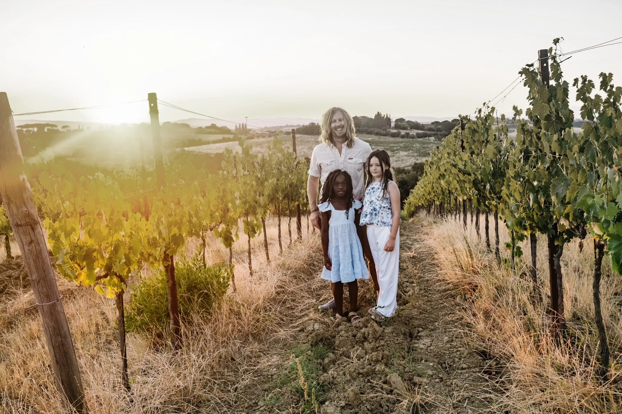 Jamey and the girls walking a vineyard row at Castello di Verrazzano in Chianti