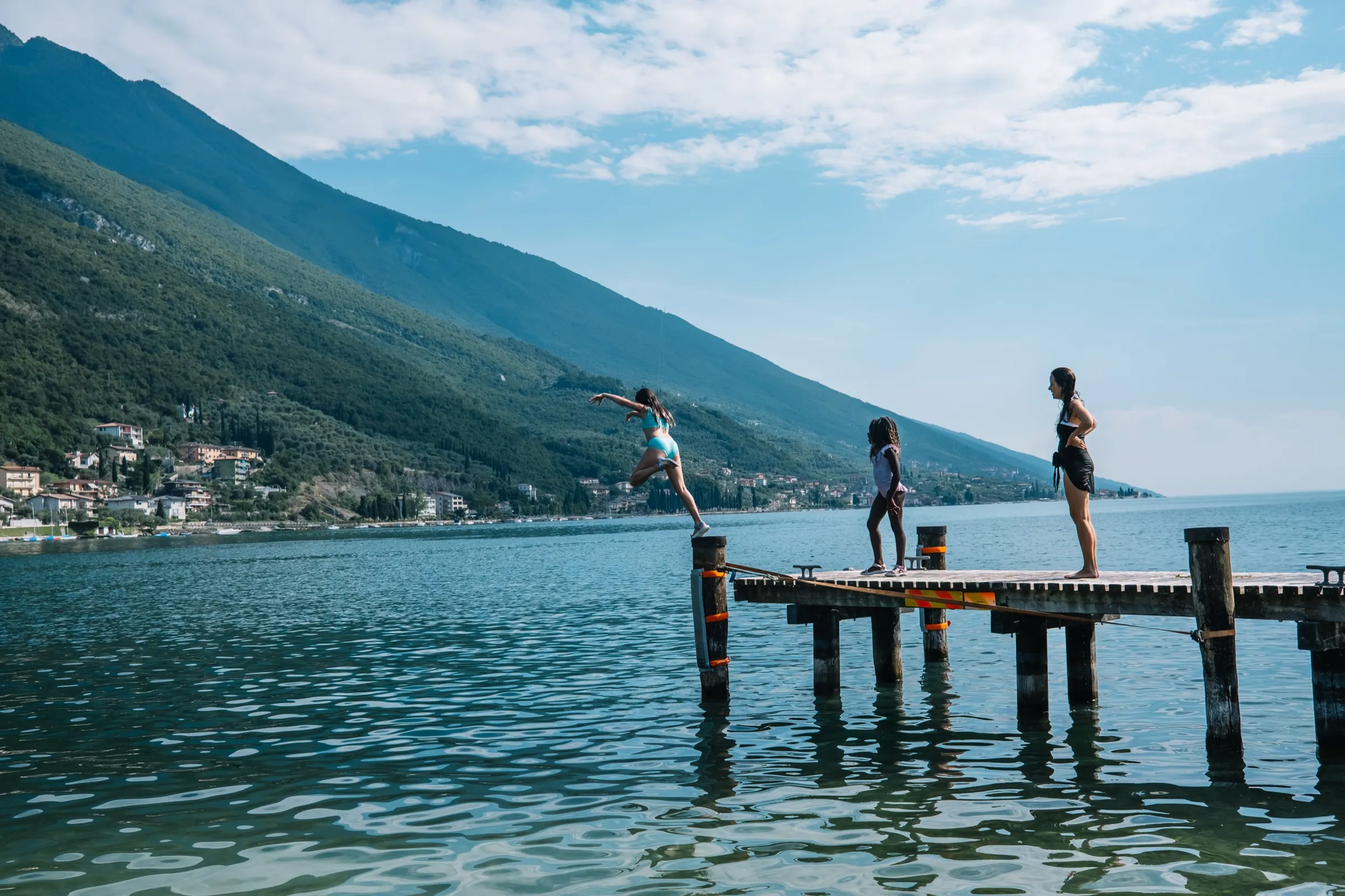 The Ice kids on a Lake Garda dock — the kind of real travel content the Ices make