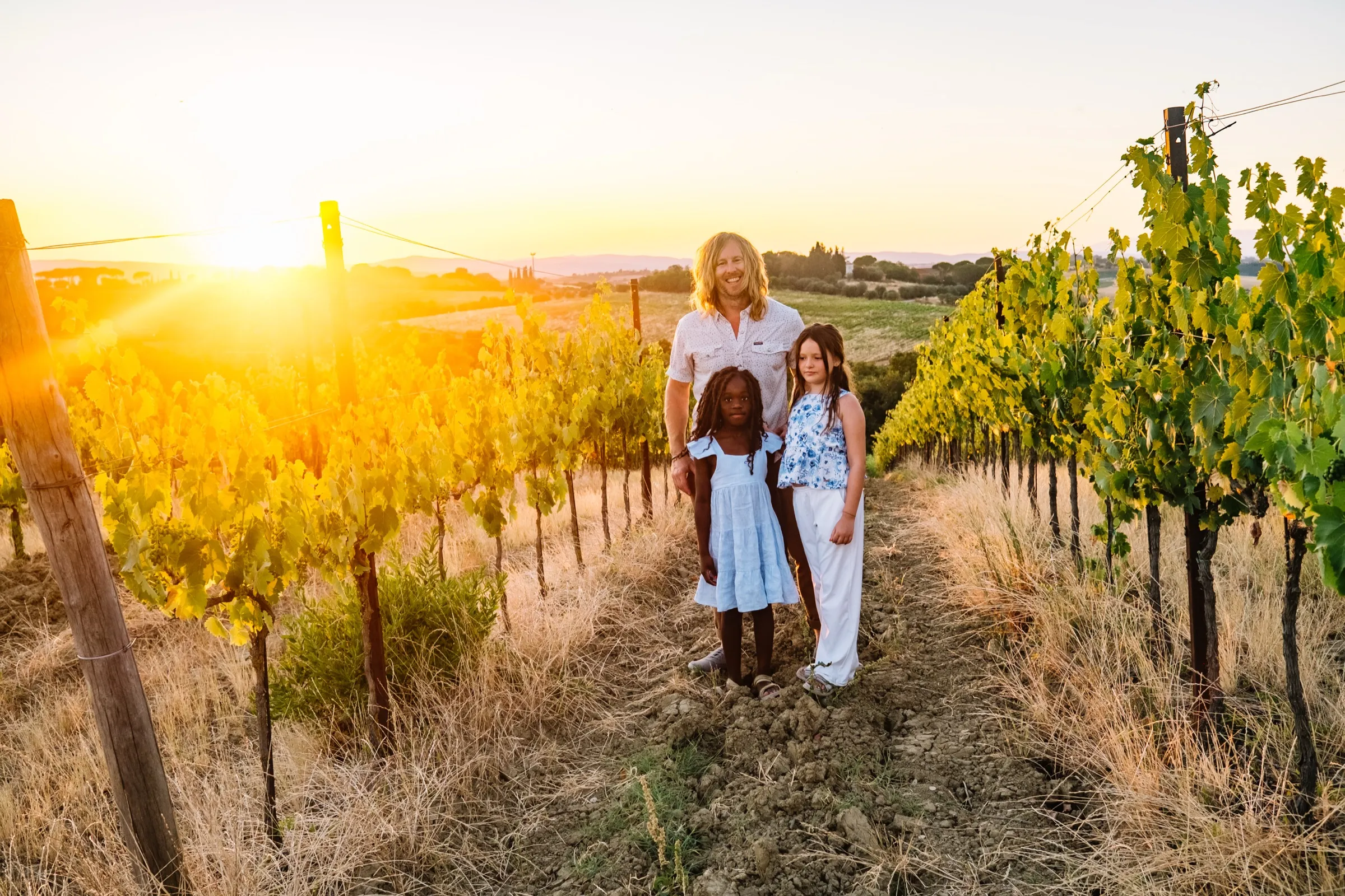 A Tuscan hillside glowing at sunset — the kind of trip points pay for