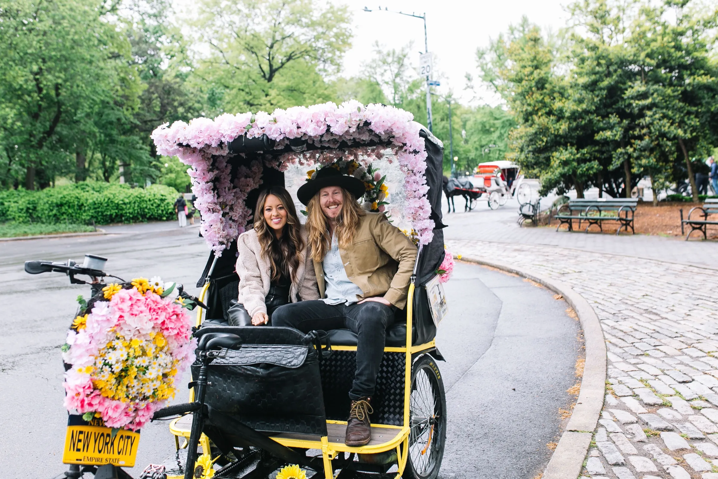 Jamey and Melissa in a flower-covered pedicab in Central Park