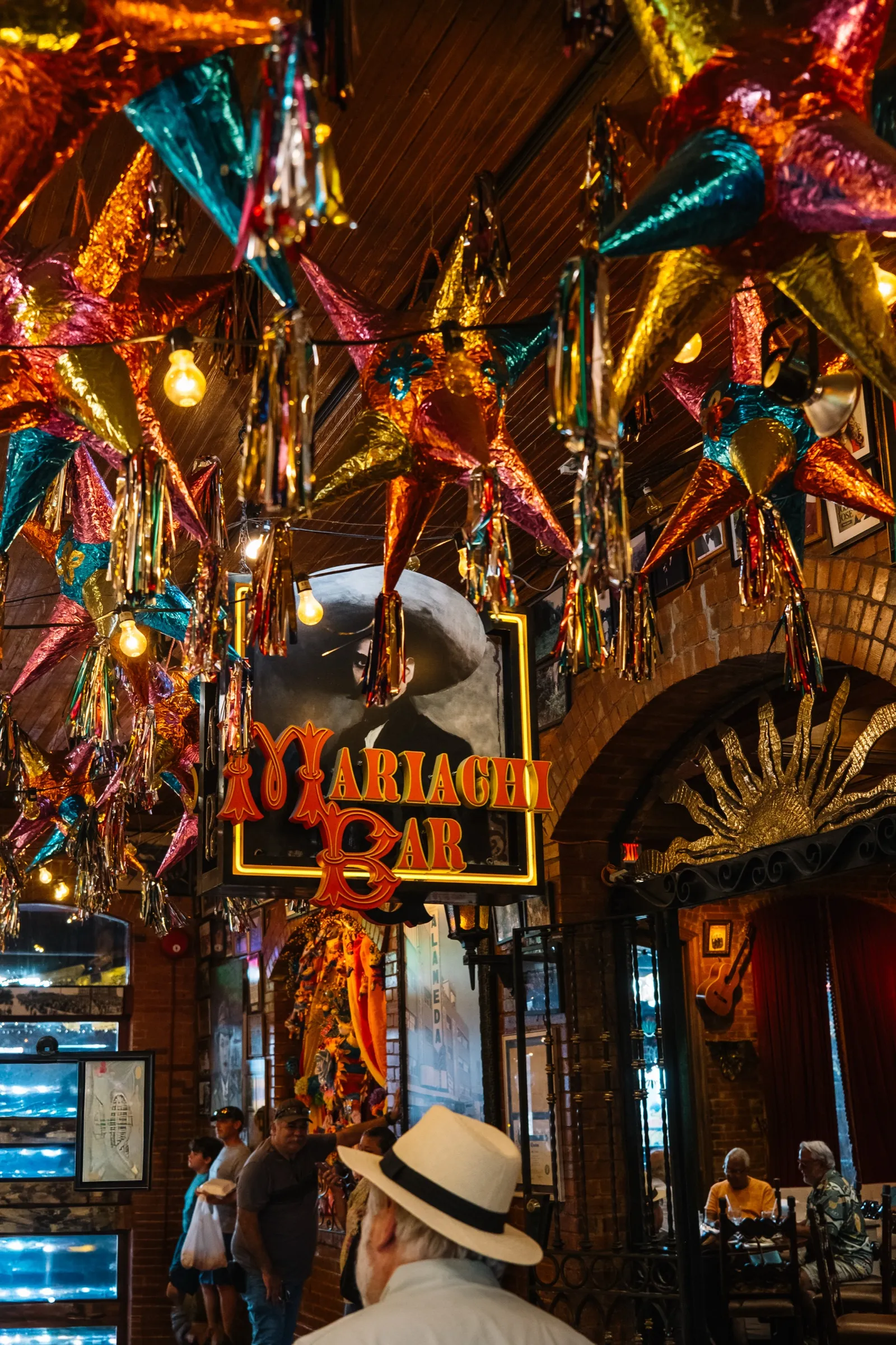The piñata-hung ceiling and neon Mariachi Bar sign inside Mi Tierra at Market Square